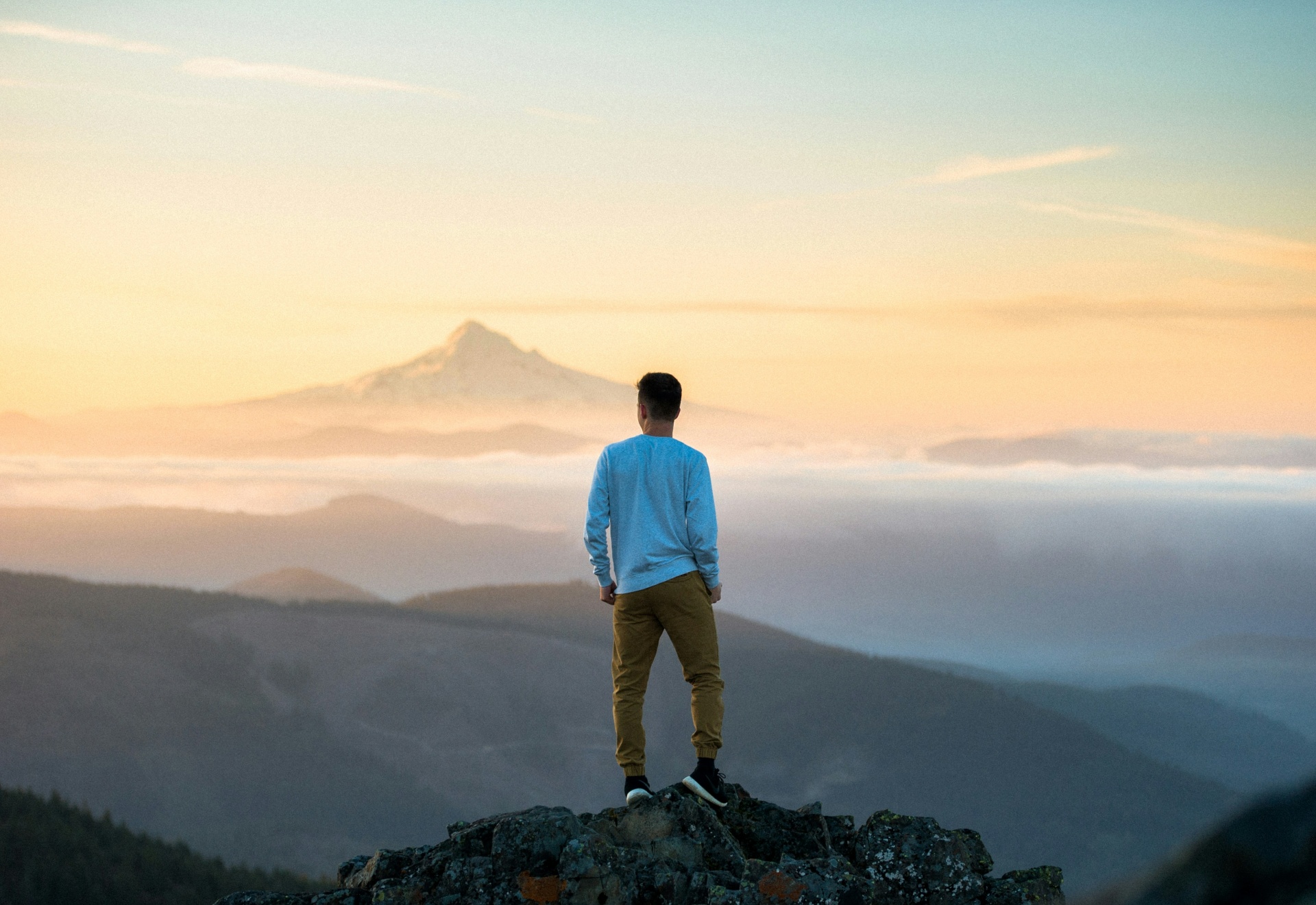 Sample tribute slideshow — a man standing on a mountain summit at sunrise